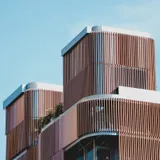 A long concrete building stepping back in horizontal bands against an open sky