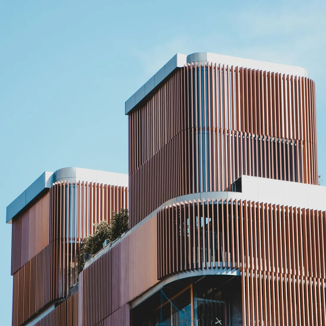 A long concrete building stepping back in horizontal bands against an open sky