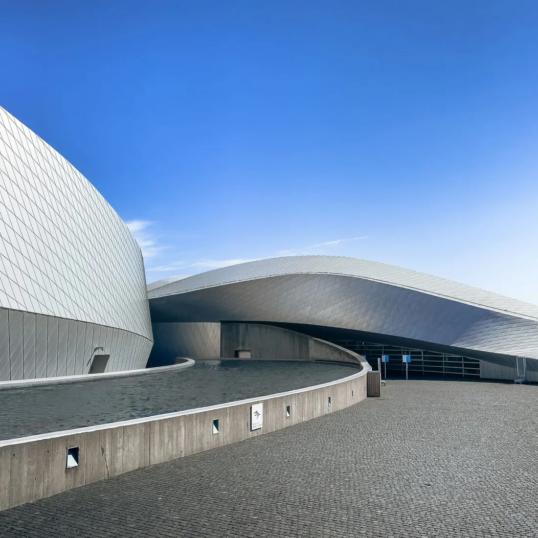 A curved building edge sweeping across an otherwise empty sky