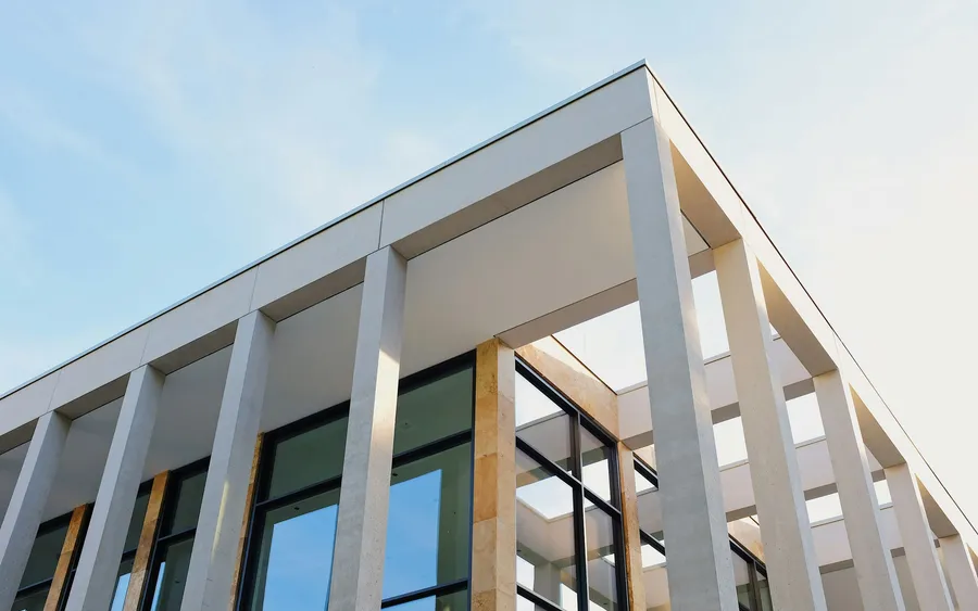 A residential block seen from below, its floors repeating to the roofline