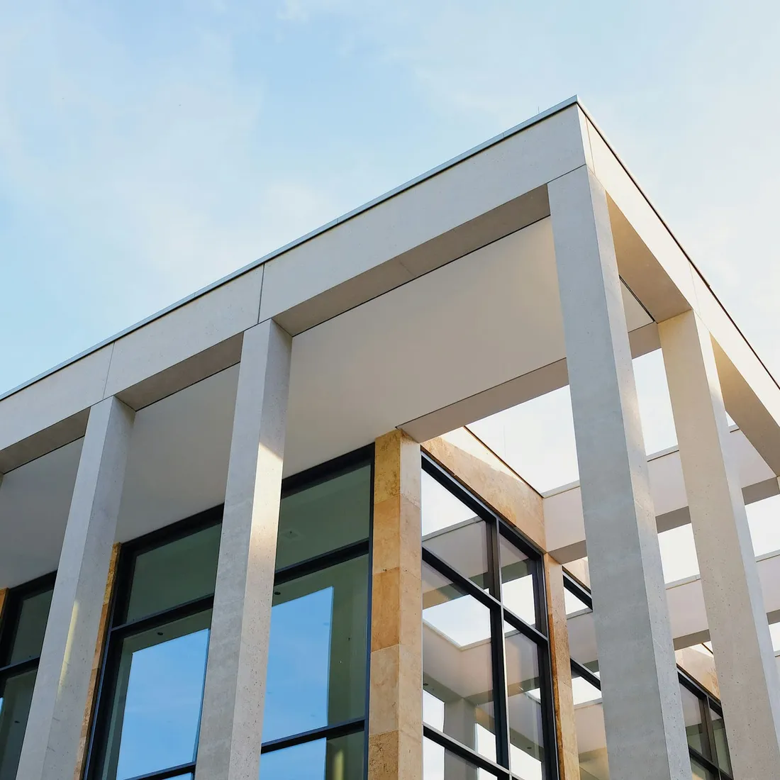 A residential block seen from below, its floors repeating to the roofline