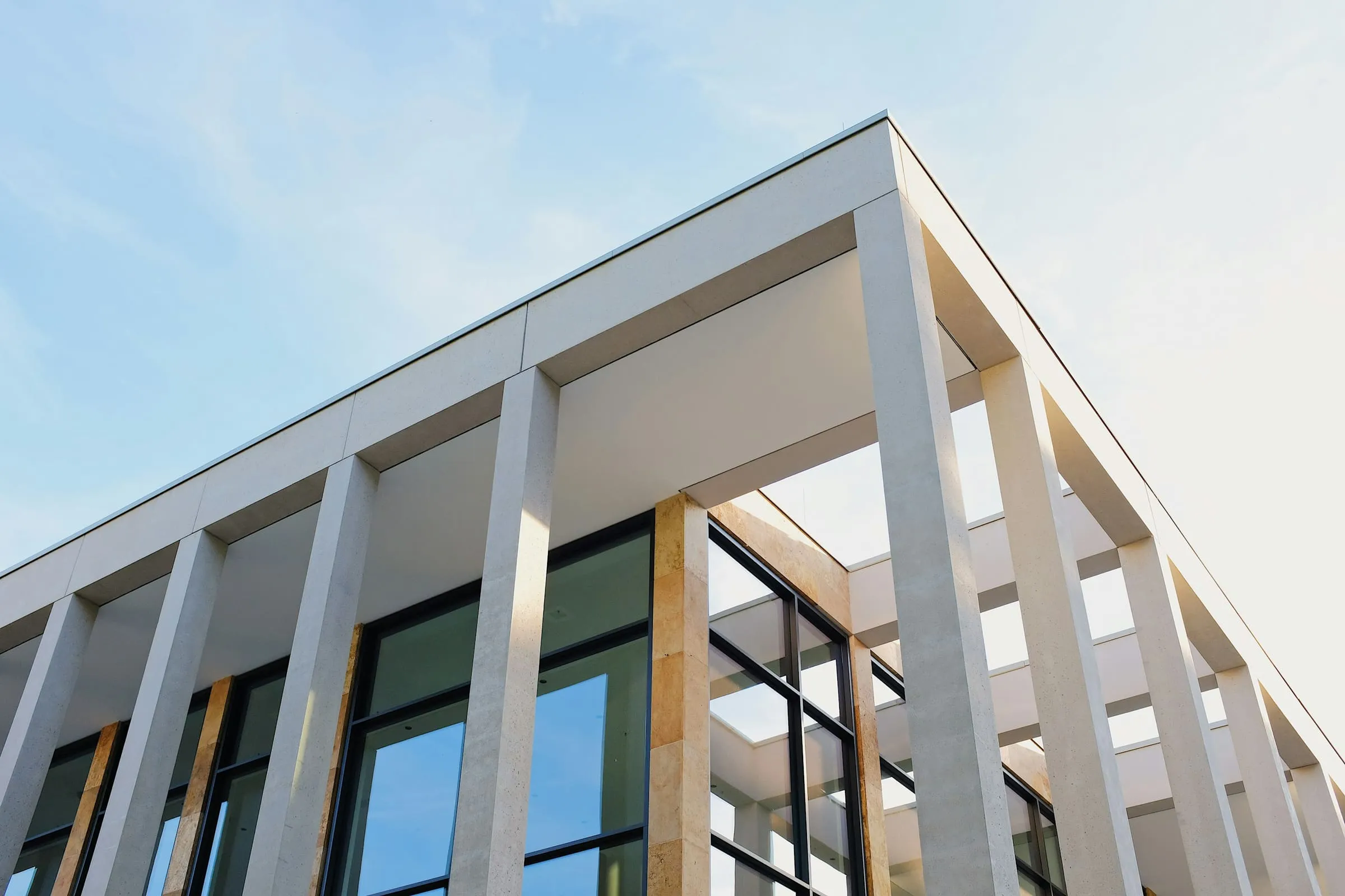 A residential block seen from below, its floors repeating to the roofline