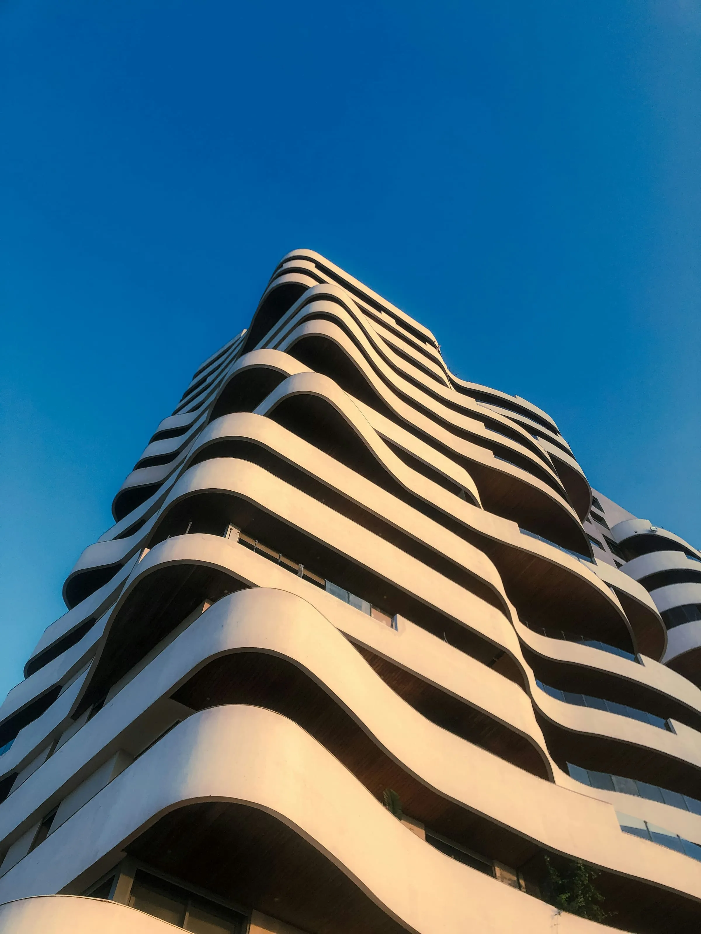 A tall residential slab, its windows repeating in an unbroken grid
