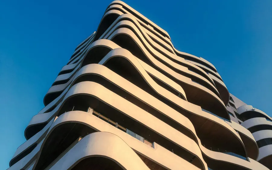 A tall residential slab, its windows repeating in an unbroken grid