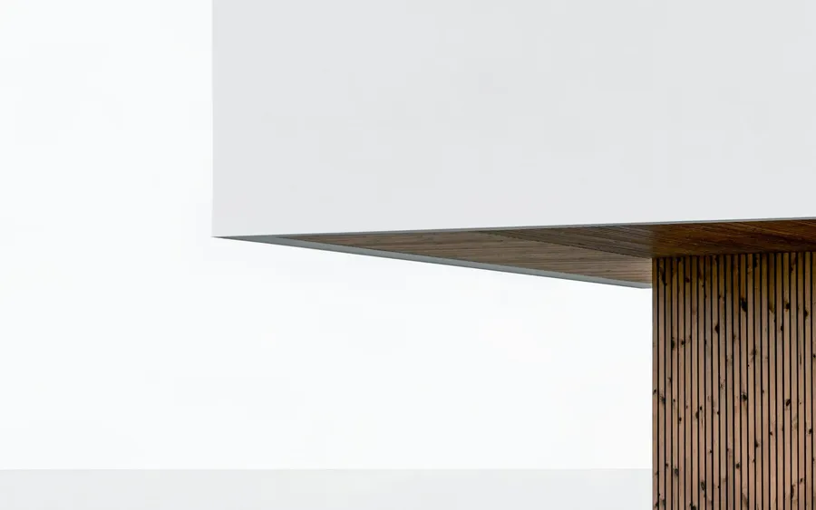 A plain painted wall holding a single soft gradient of daylight
